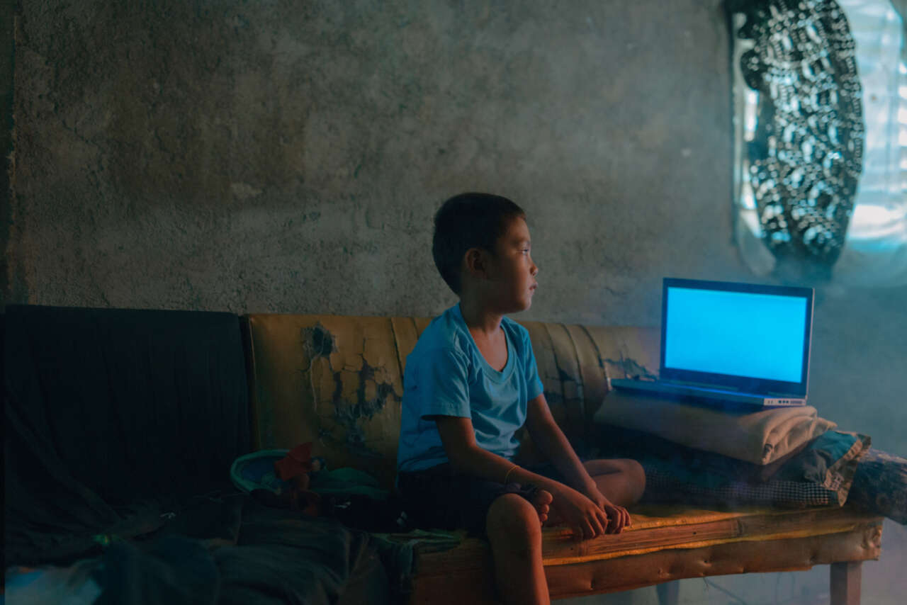 Online Sexual Exploitation of Children (OSEC) male actor looking at computer